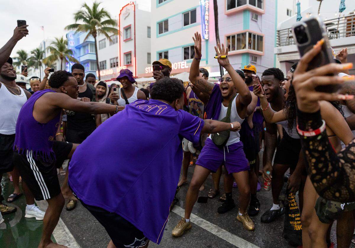Santana Melvin II, center, dances with fellow members of Alpha Delta Eta of Omega Psi Phi on Ocean Drive during spring break on Saturday, March 11, 2023, in Miami Beach, Fla.
