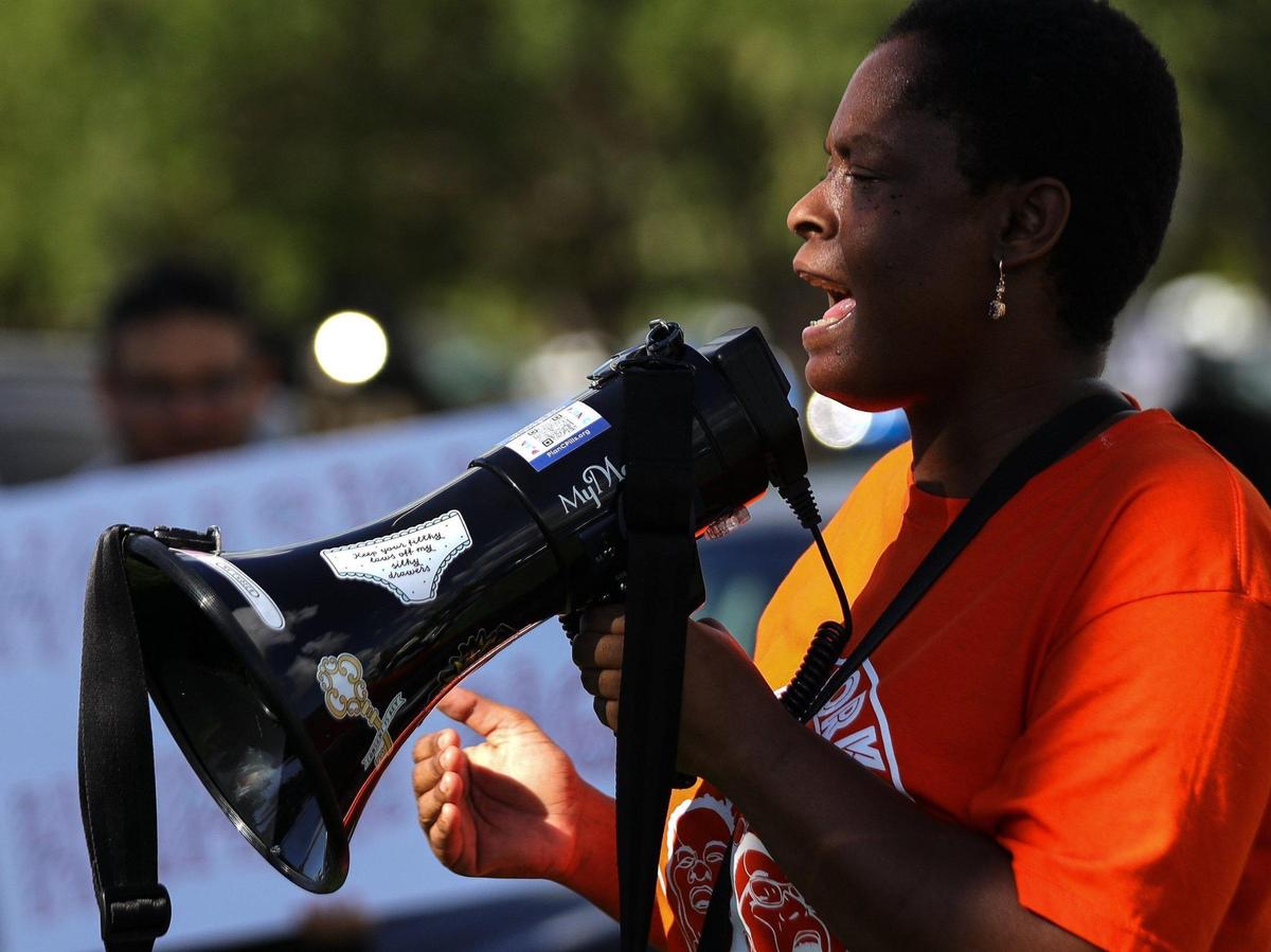 Ivory Johnson-Parker, 40, address rally attendees and states “they forgot who God is” referring those who backing the Virginia Key Beach encampment at City Hall in Coconut Grove. The Virginia Key Outdoor Center, the Miami Coalition to Advance Racial Equity, Decrim305, and others gathered outside Miami City Hall during the “stop the homeless encampment project” rally to protest against the City Commission’s Virginia Key site proposal on Tuesday, September 13, 2022.