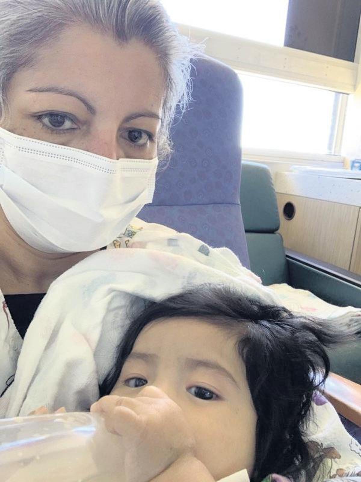 Baby Elizabeth with April Nuriu, a nurse at Salah Foundation Children’s Hospital, who has helped care for Elizabeth, diagnosed with leukemia, since her mother can’t visit as much in the pandemic.