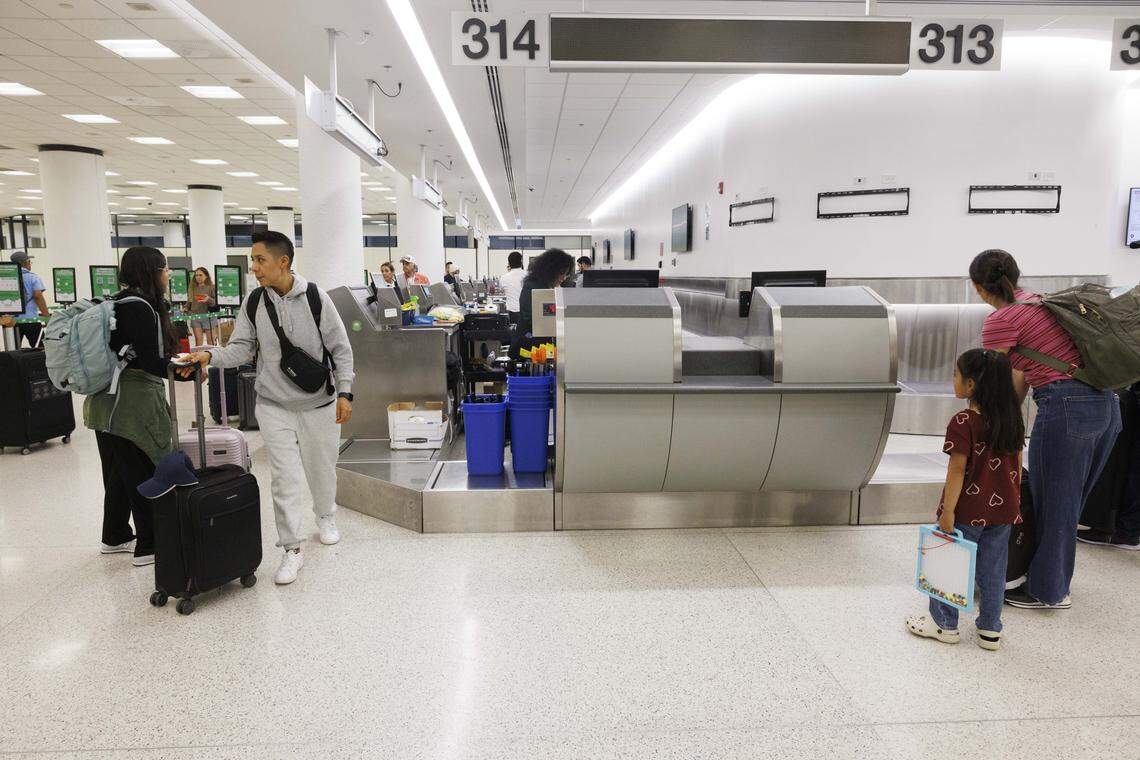 People check in to Viva Aerobus flights at a new ticketing pod in the Central Terminal during the day on Tuesday, Aug. 19, 2025, at the Miami International Airport in Miami, Fla. The airport recently finished construction on three new pods, sections of ticketing counters, in the Central Terminal. 