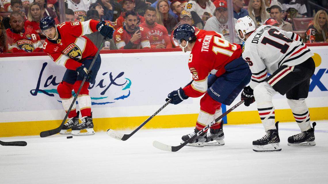 Florida Panthers center Sam Reinhart (13) passes the puck to left wing Matthew Tkachuk (19) while Chicago Blackhawks center Jason Dickinson (16) defends during the second period of an NHL game at the Amerant Bank Arena on Sunday, Nov 12, 2023, in Sunrise, Fla.