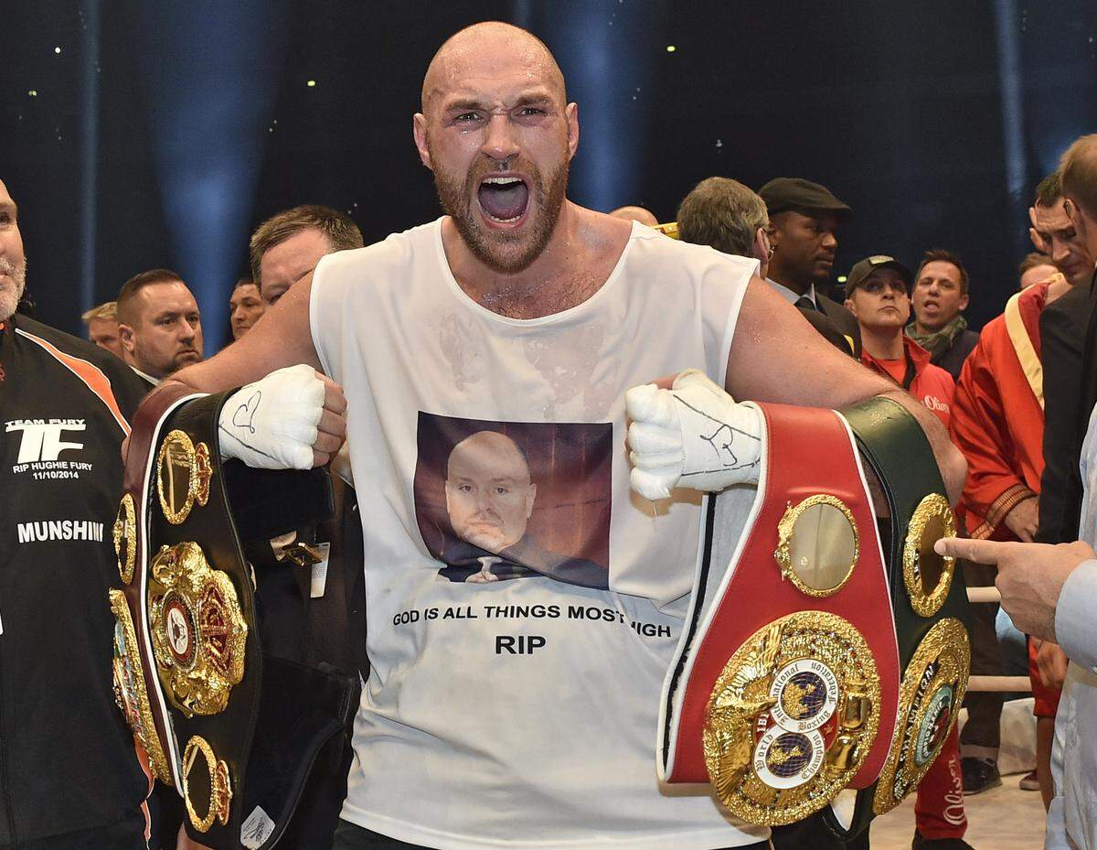 FILE - In this Nov. 29, 2015 file photo, Britain’s new world champion Tyson Fury, celebrates with the WBA, IBF, WBO and IBO belts after winning the world heavyweight title fight against Ukraine’s Wladimir Klitschko in Duesseldorf, western Germany. Tyson Fury’s boxing career could be over after the reigning IBF, WBO and WBA heavyweight champion announced his retirement in a profanity-filled tweet on Monday Oct. 3, 2016. (AP Photo/Martin Meissner, File)