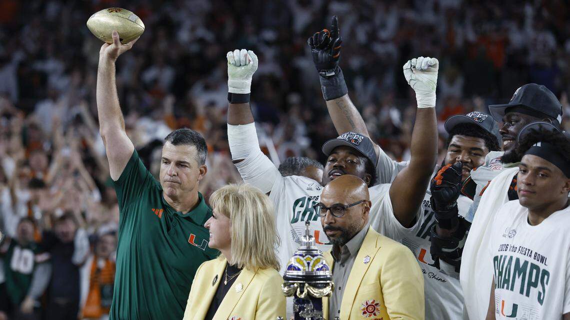 Miami Hurricanes head coach Mario Cristobal raises the Fiesta Bowl Trophy after the Canes defeat the Mississippi Rebels in the College Football Playoff semifinal at the Fiesta Bowl at State Farm Stadium on Thursday, January 8, 2026 in Glendale, Arizona.