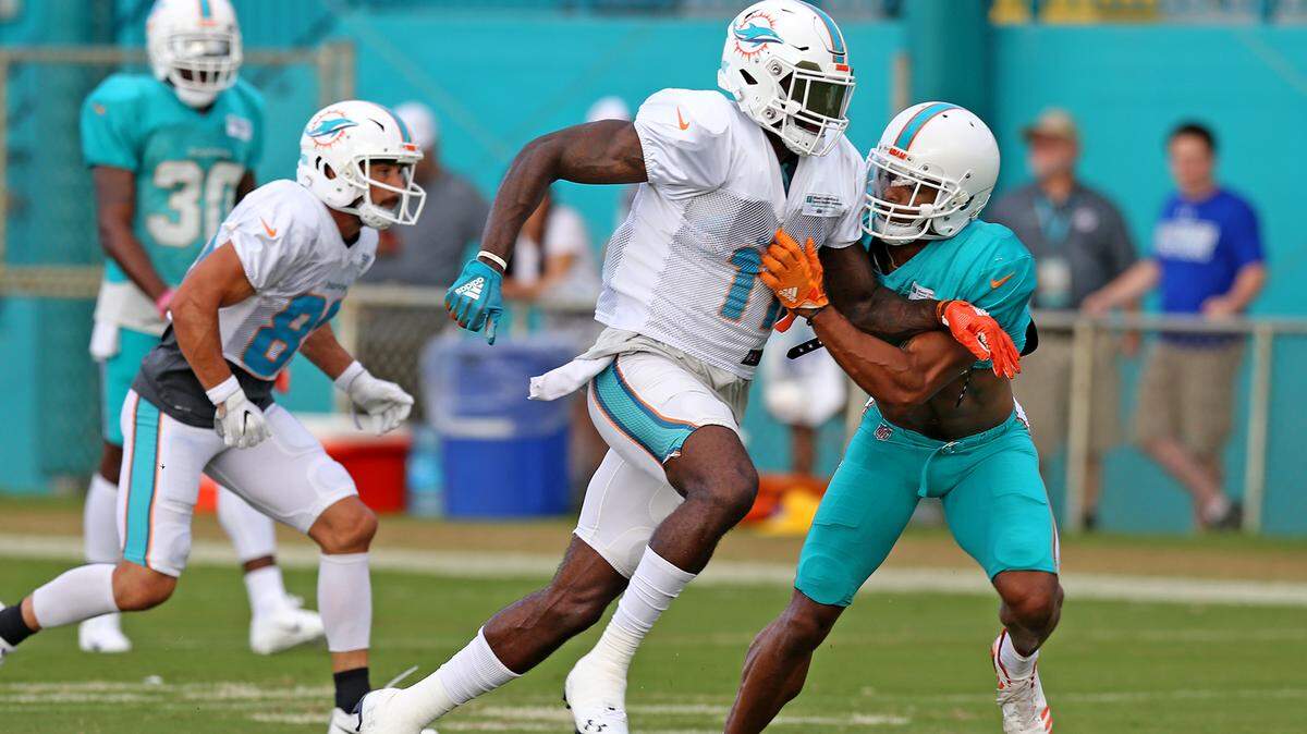Miami Dolphins receiver DeVante Parker is well covered by rookie safety Minkah Fitzpatrick during training camp.