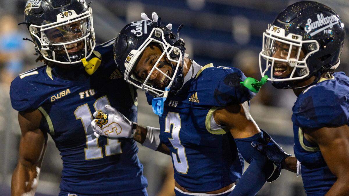 Florida International University Panthers wide receiver Eric Rivers (3) celebrates with teammates Dean Patterson (11) and C’Quan Jnopierre (7) after scoring a touchdown during the second half of an NCAA Conference USA football game against the New Mexico State Aggies at Pitbull Stadium on Tuesday, October 29, 2024, in Miami, Fla.
