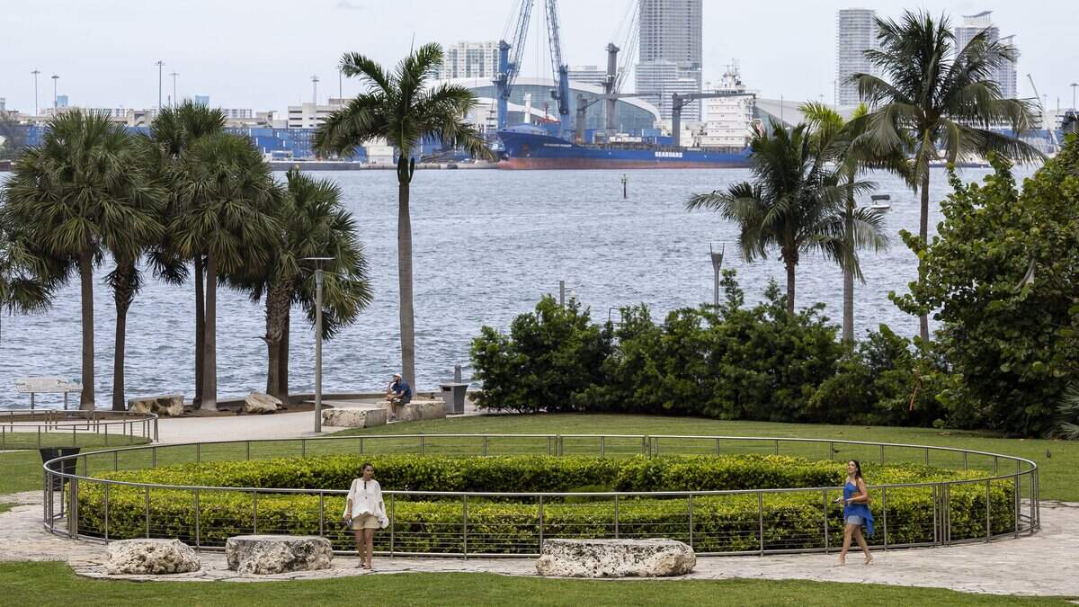 People stroll by the Miami Circle National Historic Landmark, a 2,000-year-old indigenous site in Brickell where the Miami River meets Biscayne Bay.