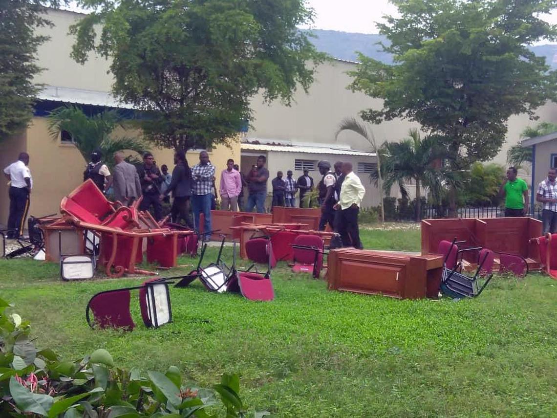 The lawn outside Haiti’s parliament on Thursday was littered with broken desks and chairs, thrown out by opposition senators.