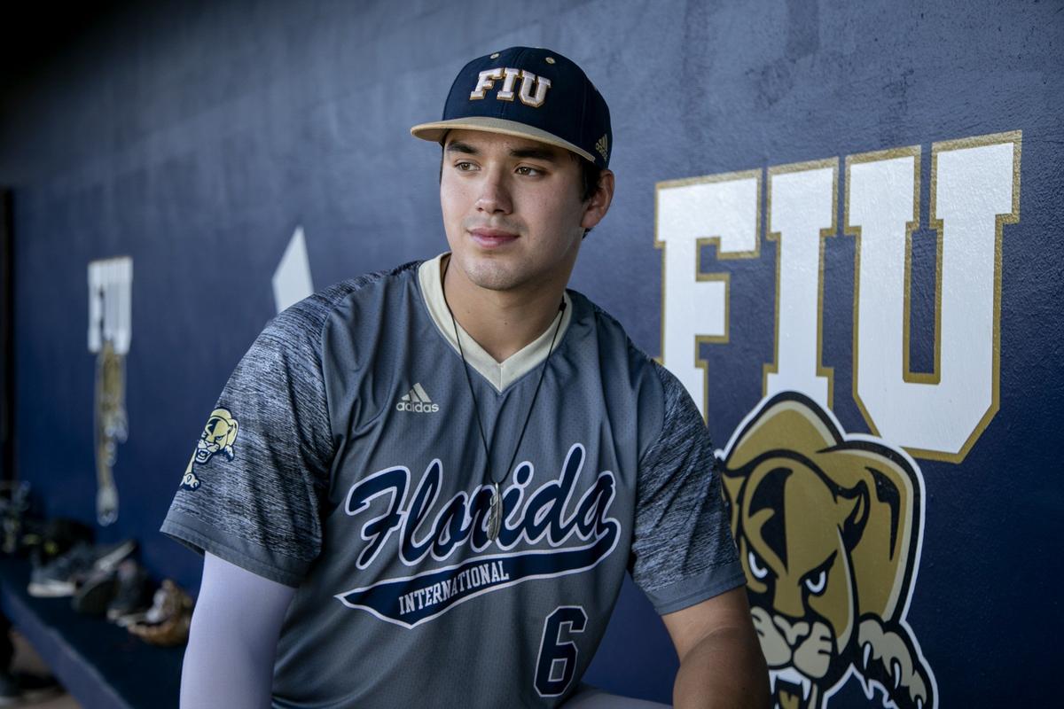 FIU third baseman Austin Shenton looks on from the dugout during practice on Thursday, Feb. 7, 2019.
