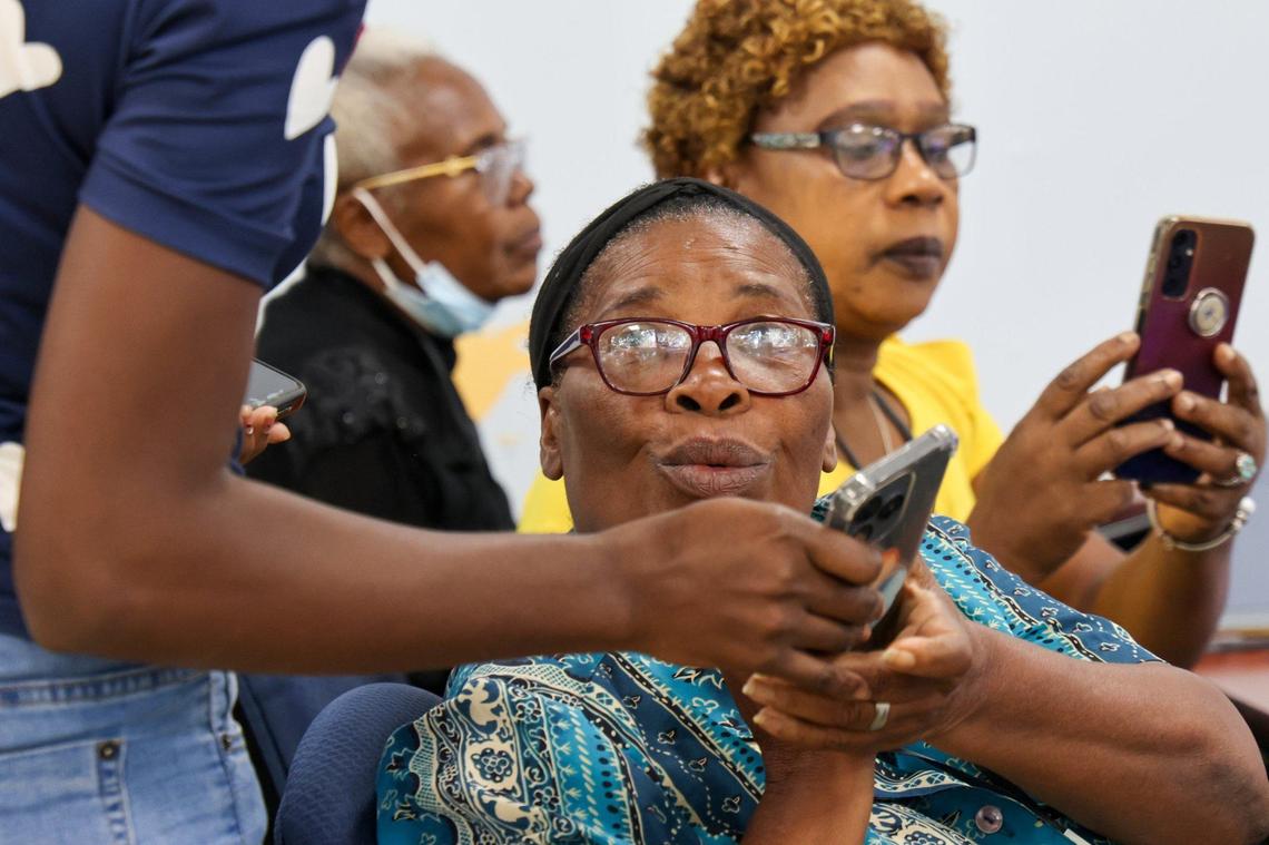 Marie Marianne Darismond Candio, center, gets assistance from assistant instructor Stephanie Antione as she takes a computer class. In this class, students learn how to type using computer keyboards. About forty adult Haitian students attended a computer class at the Pierre Toussaint Leadership and Learning Center in the Little Haiti neighborhood of Miami, Florida, to learn digital skills and ease the pathway into employment on Wednesday, September 25, 2024.