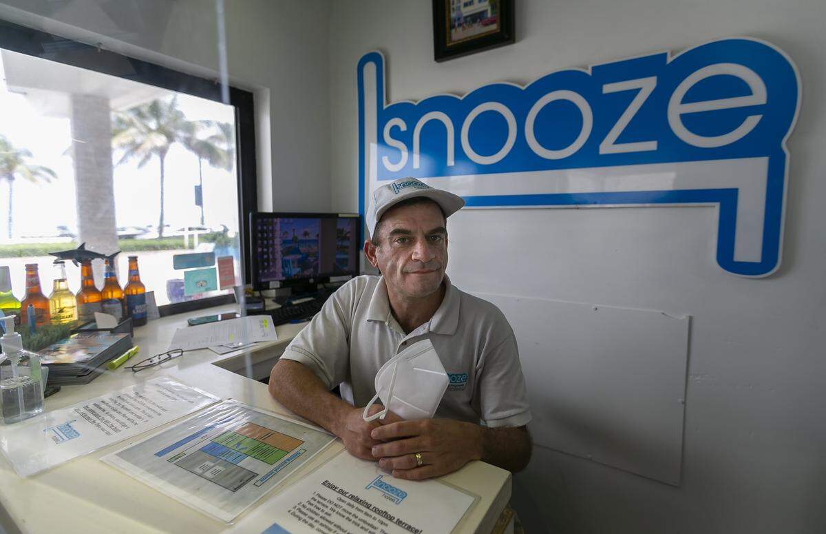 Matt Denson, the general manager of Snooze Hotel, prepares for guests at his hotel near Las Olas Beach in Fort Lauderdale on May 26. It was the first day in more than two months that hotels were allowed to take in all guests after restrictions related to COVID-19 were lifted.