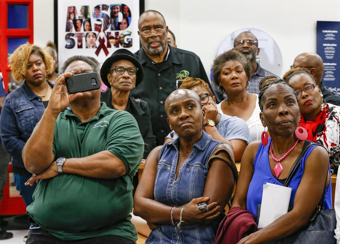 Concerned citizens stand outside and watch the Broward School Board meeting on a hallway monitor on Tuesday, March 5, 2019.