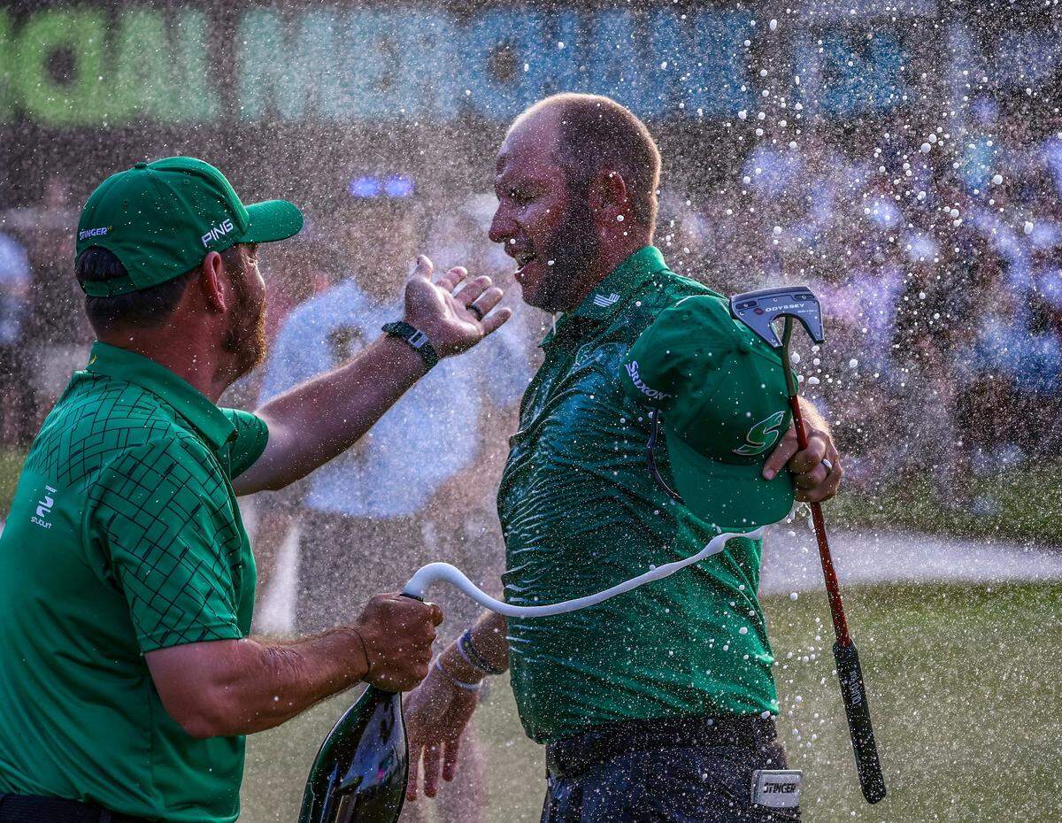 Dean Burmester gets showered by Louis Oosthuizen,left, after winning the LIV Golf Miami at in two sudden death playoffs to defeat Sergio Garcia at the Trump National Doral on Sunday, April 7, 2024 in Doral, Florida.