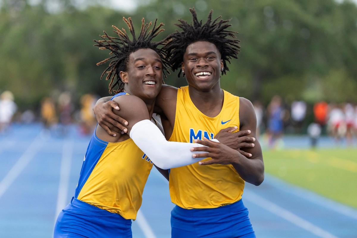 Tywan Cox, left, and J’Vari Flowers, both from Miami Northwestern Senior High, celebrate after competing in the boys 200 meter dash during the GMAC track and field championships at the Traz Powell Stadium on Thursday, April 11, 2024, in Miami, Fla. Cox placed first.