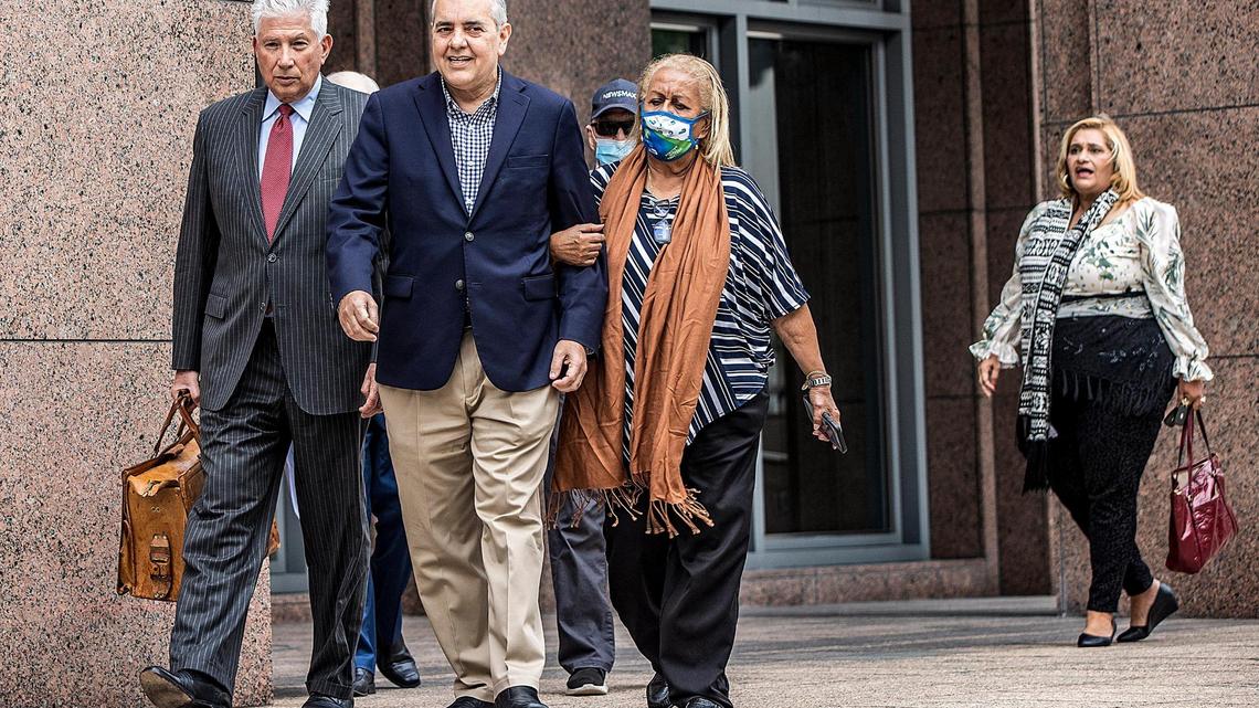Former U.S. Rep. David Rivera (center) walks out of court with lawyer Jeffrey Feldman and a supporter named Rosa Peña, after his first federal court appearance before Magistrate Judge Jonathan Goodman at the James Lawrence King Criminal Justice Building in Miami, on Tuesday, Dec. 20, 2022.