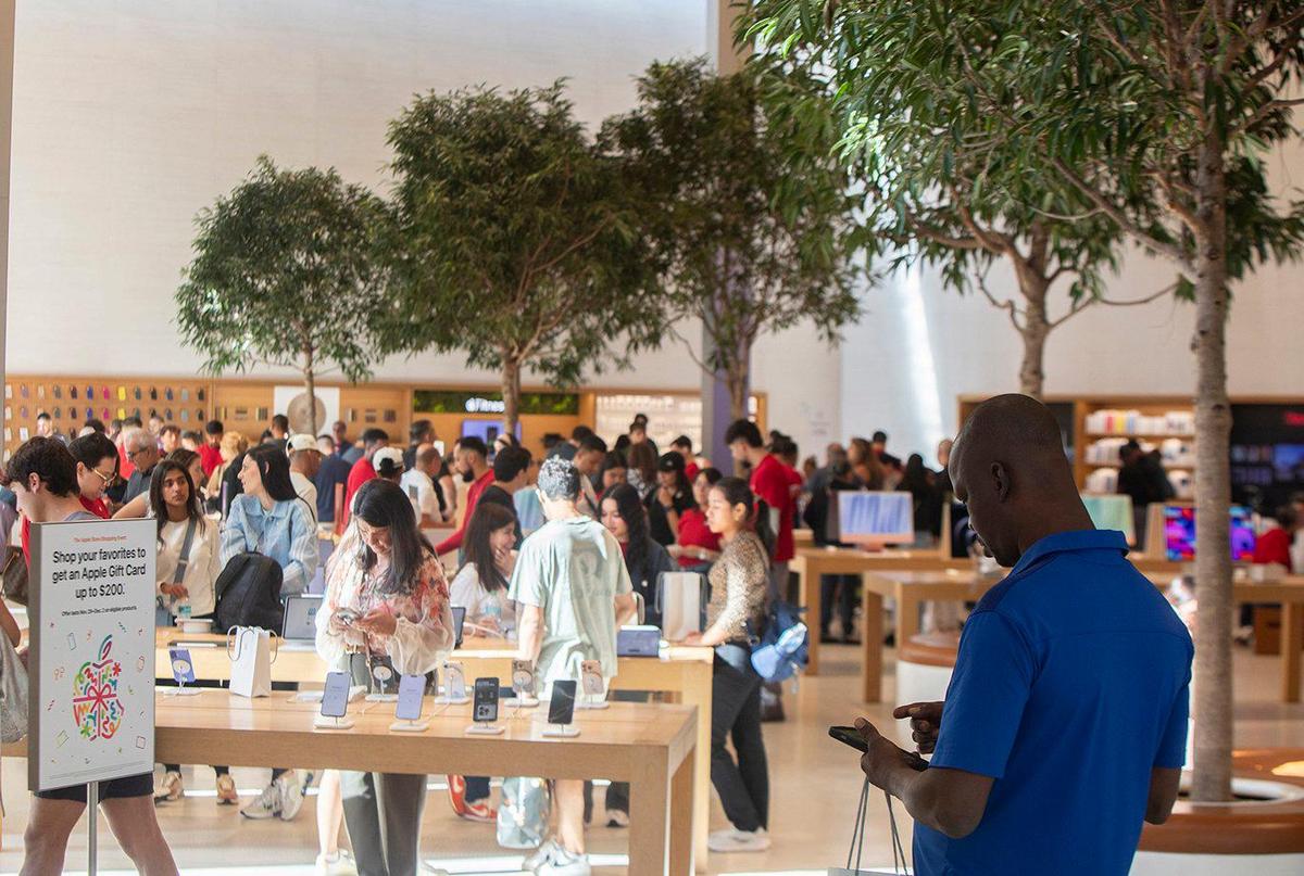 Shoppers in the Apple store peruse the latest iPhone, Mac and iPad models at Dadeland Mall on Friday, Nov. 29, 2024.