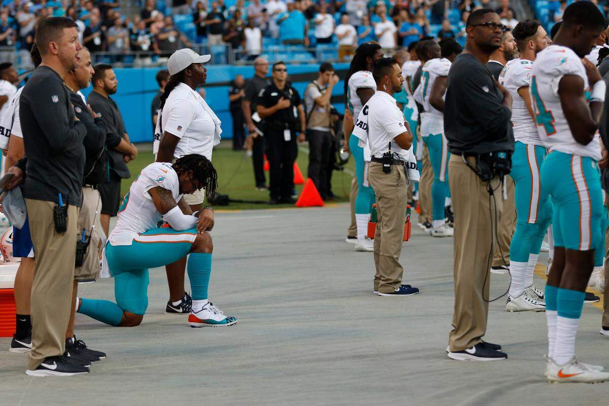 Miami Dolphins’ Albert Wilson (15) kneels during the national anthem before a preseason NFL football game against the Carolina Panthers in Charlotte, N.C., Friday, Aug. 17, 2018. (AP Photo/Nell Redmond)