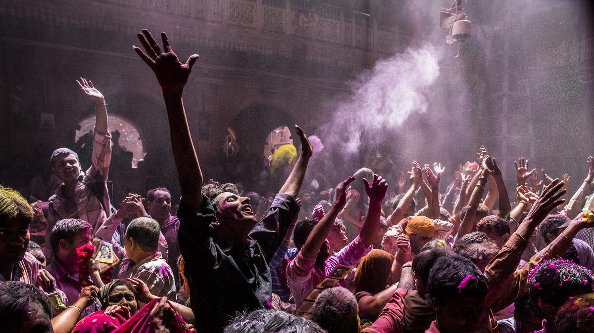 Hindu devotees play with colour during Holi celebrations at the Banke Bihari temple on March 27, 2013 in Vrindavan, India.