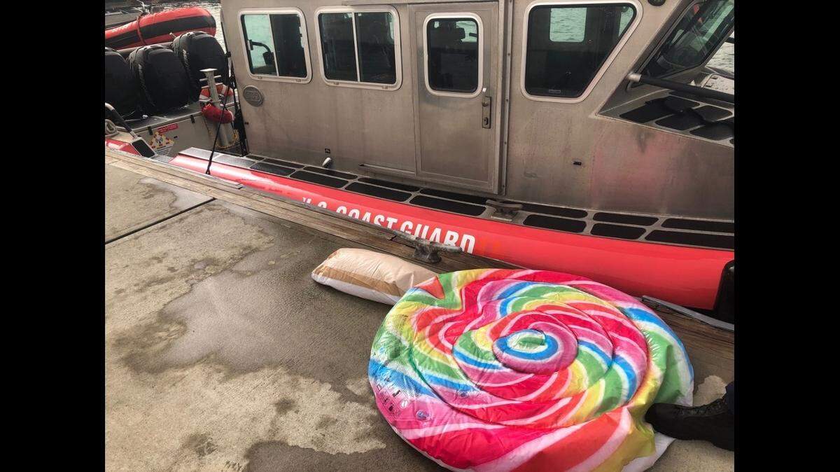 The raft on which the girl, estimated age 4 to 6 years, had floated out to sea from Isla de Cabras, Toa Baja, Puerto Rico. Behind the raft, Coast Guard Boat Station San Juan’s 33-foot Special Purpose Craft – Law Enforcement