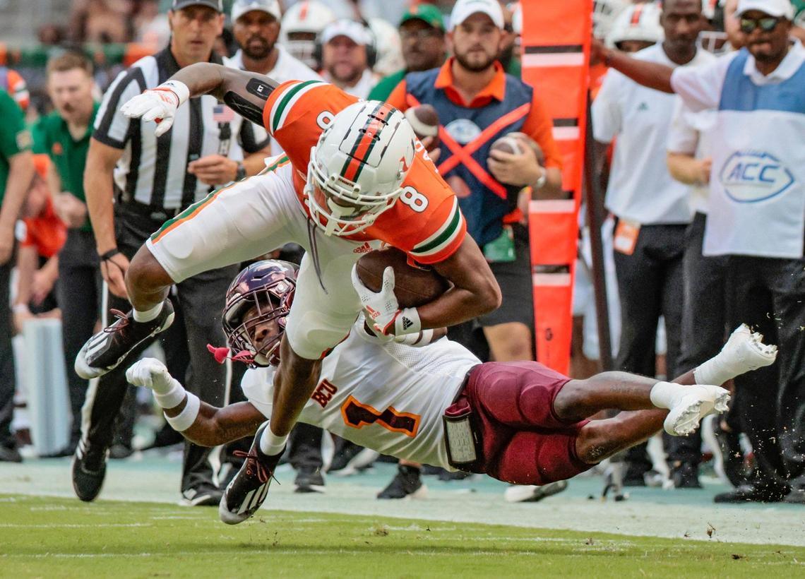 Miami Hurricanes wide receiver Frank Ladson Jr. (8) earns a first down reception as Bethune Cookman Wildcats cornerback Omari Hill-Robinson (1) defends in the first quarter at Hard Rock Stadium in Miami Gardens on Saturday, September 3, 2022.