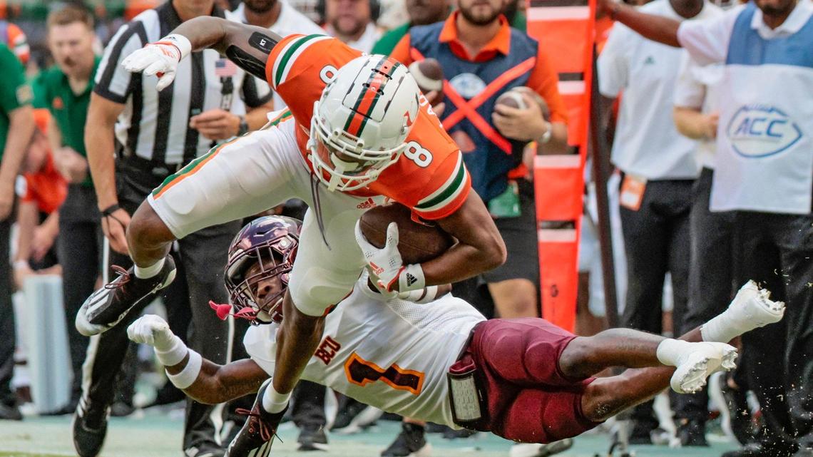 Miami Hurricanes wide receiver Frank Ladson Jr. (8) earns a first down reception as Bethune Cookman Wildcats cornerback Omari Hill-Robinson (1) defends in the first quarter at Hard Rock Stadium in Miami Gardens on Saturday, September 3, 2022.