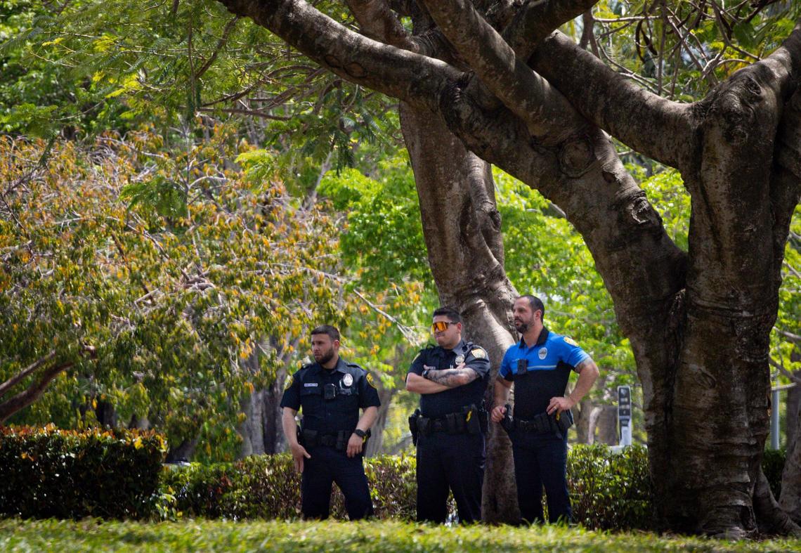 Police officers watch from across lawn during a gathering hosted by FIU students about Mahmoud Khalil, the Columbia student who faces deportation over his pro-Palestinian activism, on Wednesday, March 26, 2025, outside the Florida International University Ernest R.Graham Center in Miami, Fla.