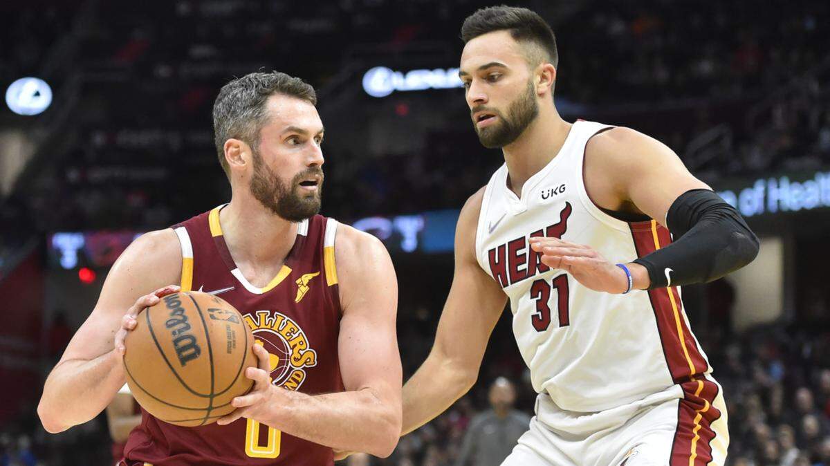 Dec 13, 2021; Cleveland, Ohio, USA; Miami Heat guard Max Strus (31) defends Cleveland Cavaliers forward Kevin Love (0) in the third quarter at Rocket Mortgage FieldHouse. Mandatory Credit: David Richard-USA TODAY Sports