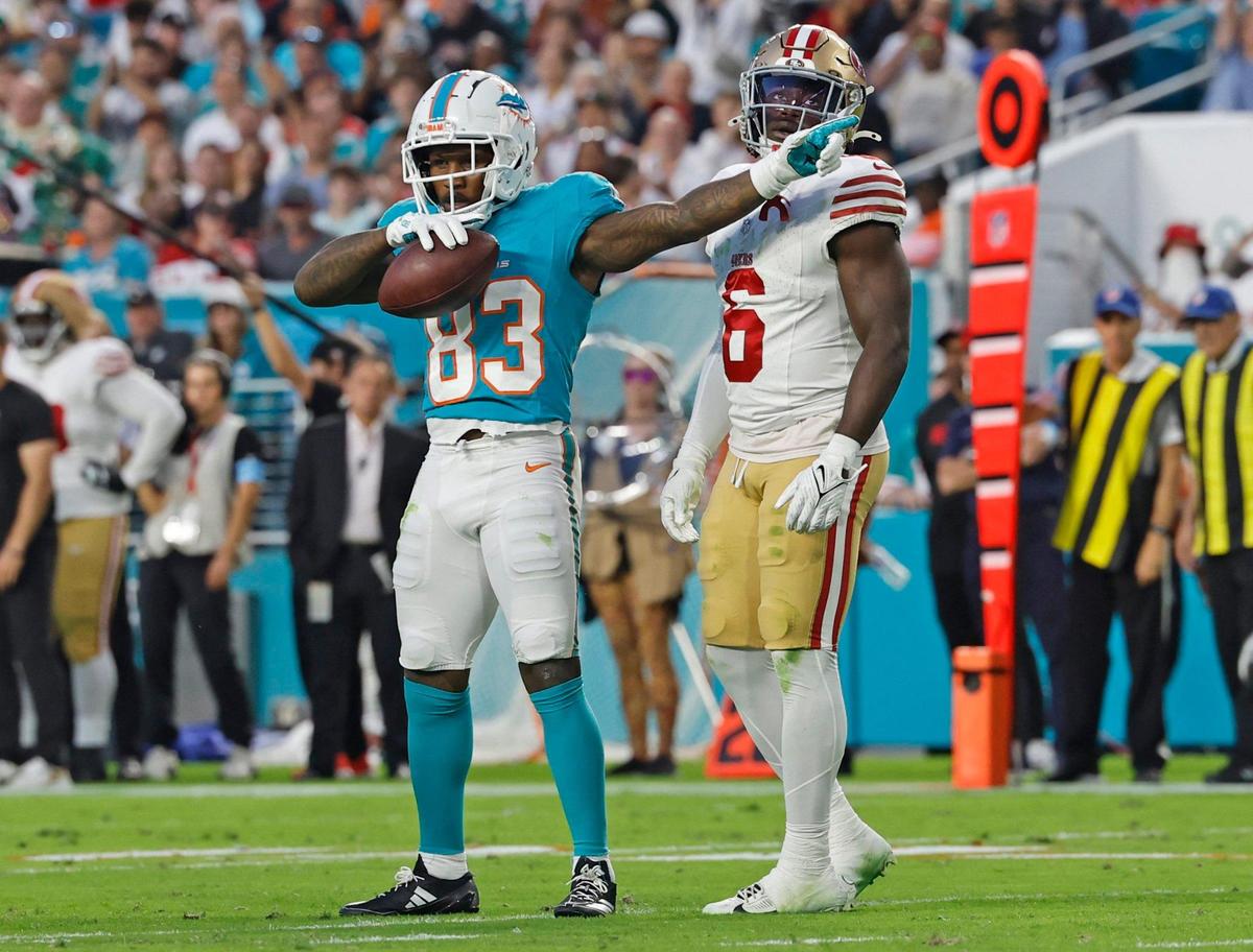 Miami Dolphins wide receiver Malik Washington (83) signals a first down near the end zone as San Francisco 49ers safety Malik Mustapha (6) looks on during the first half of an NFL Football game at Hard Rock Stadium in Miami Gardens, Florida, on Sunday, December 22, 2024.