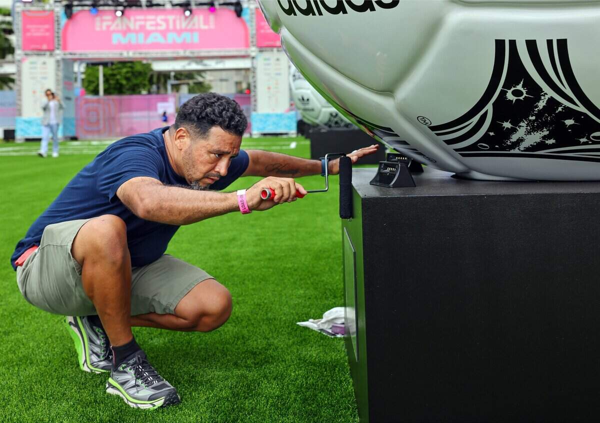 Jorge Gonzalez spreads an adhesive as he installs small lights for the World Cup exhibit labels at the FIFA Fan Festival Miami at Bayfront Park. The FIFA World Cup 2026TM Miami Host Committee invited media to an exclusive FIFA Fan Festival Miami Media Preview Day on Wednesday, June 10, 2026, in Miami, Florida, offering a first look at the central gathering place for hundreds of thousands of fans during the FIFA World Cup 2026.