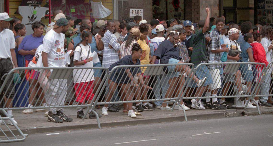 A crowd on Peachtree Street near Underground Atlanta on Saturday, April 22, 1995 pushes over a city barricade in open defiance of a group of nearby police officers. The gathering centered around the three day long Freaknik ’95 celebration. Freaknik was an annual gathering of students from traditionally Black colleges in Atlanta. (AP Photo/Andrew Innerarity)