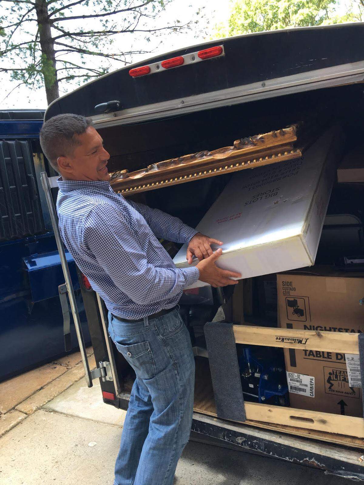 Boris Ochoa, who fled Guatemala 30 years ago, helps former Guatemala top prosecutor Thelma Aldana unpack donated goods to help her establish herself in the United States.
