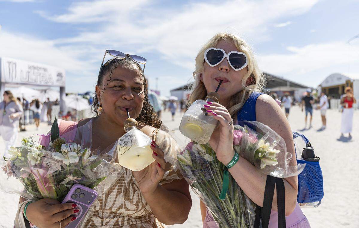 Savannah Sanders, left, and Melissa Cardona sip a drink as they attend the Goya Foods' Grand Tasting Village during the Food Network South Beach Wine & Food Festival on Saturday, Feb. 21, 2026, in Miami Beach, Fla.