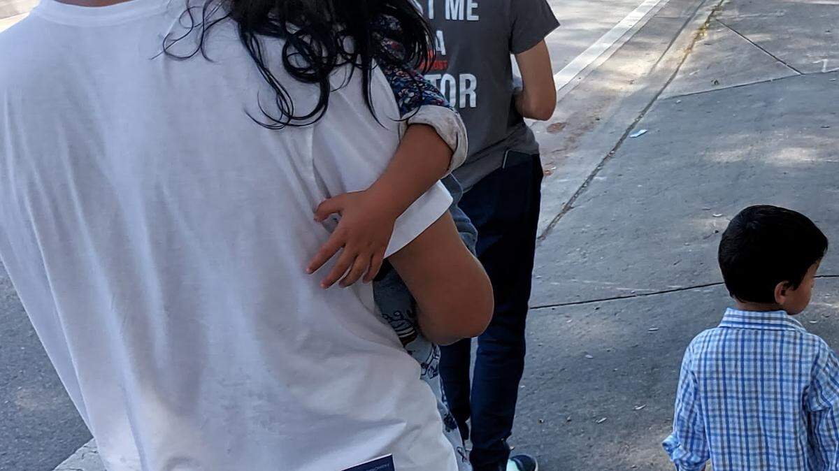 A newly arrived refugee family walks to the home that Church World Services helped set up for them through donations from the public.