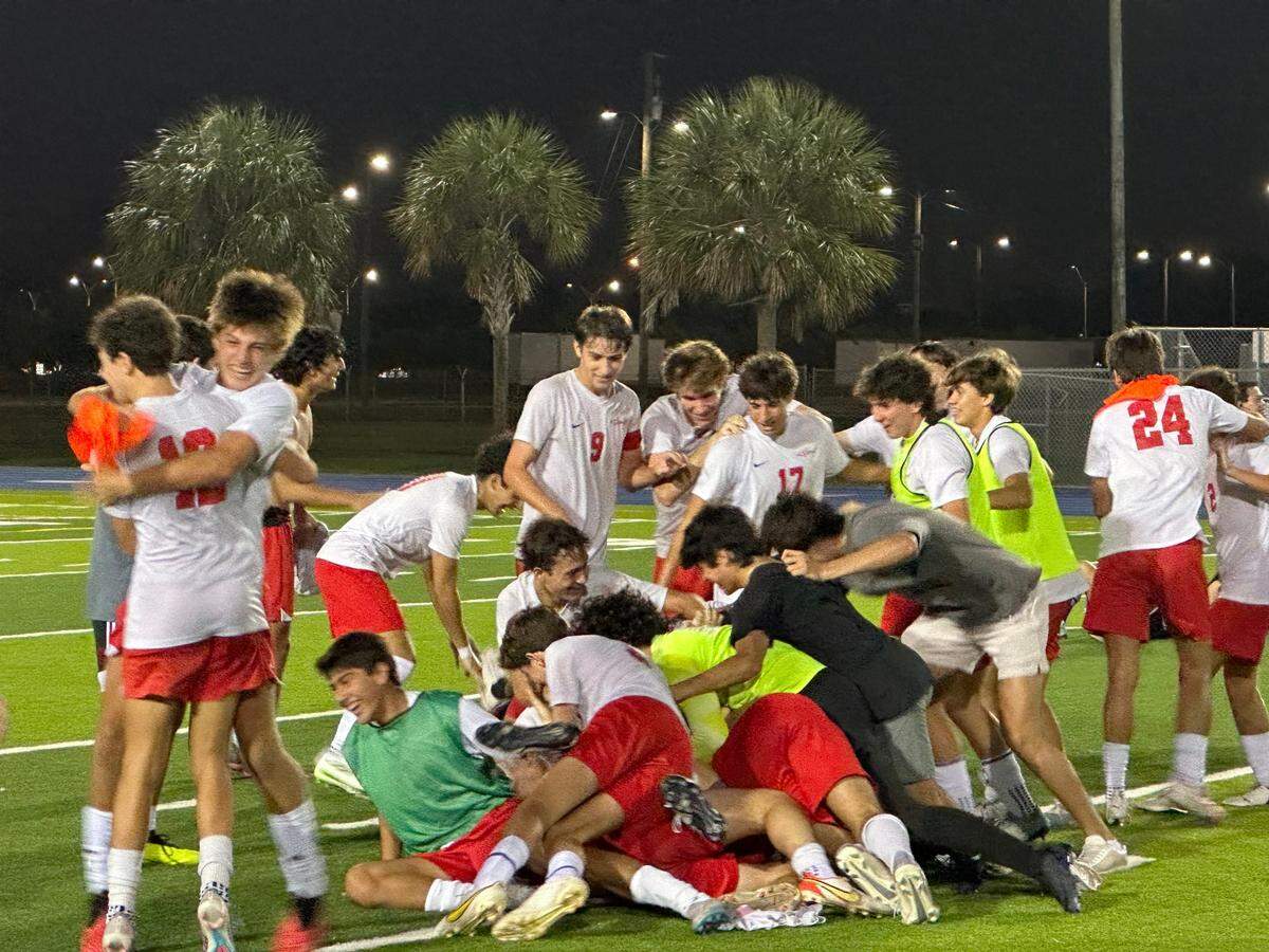 MAST Academy players celebrate after winning their first GMAC boys’ soccer championship on Friday night at Traz Powell Stadium.