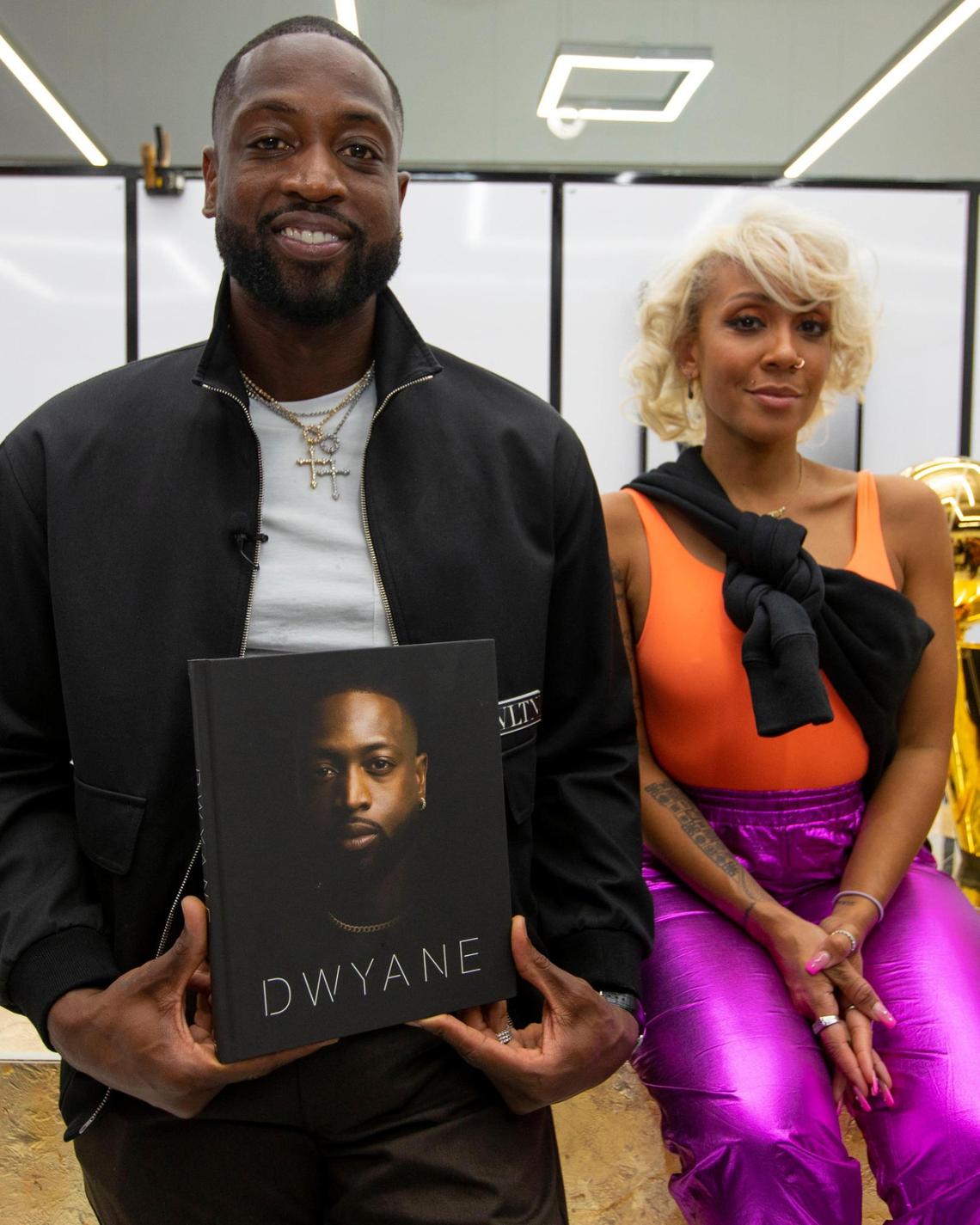 Miami Heat legend Dwyane Wade poses for a photo with stylist Calyann Barnett after a moderated discussion for his new memoir “Dwyane.” at The Shop Miami in the Wynwood neighborhood of Miami, Florida, on Friday, November 19, 2021.