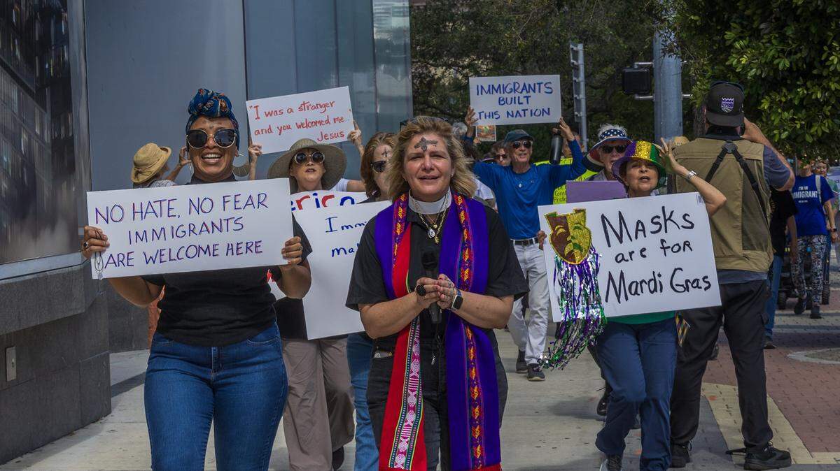 Rev. Dr. Audrey Warren, pastor of First United Methodist Church of Miami, leads a group of immigrants advocates on a march for Immigrants beginning at First Church Miami and ending at the Immigration Court in downtown Miami, on Wednesday, February 18, 2026.