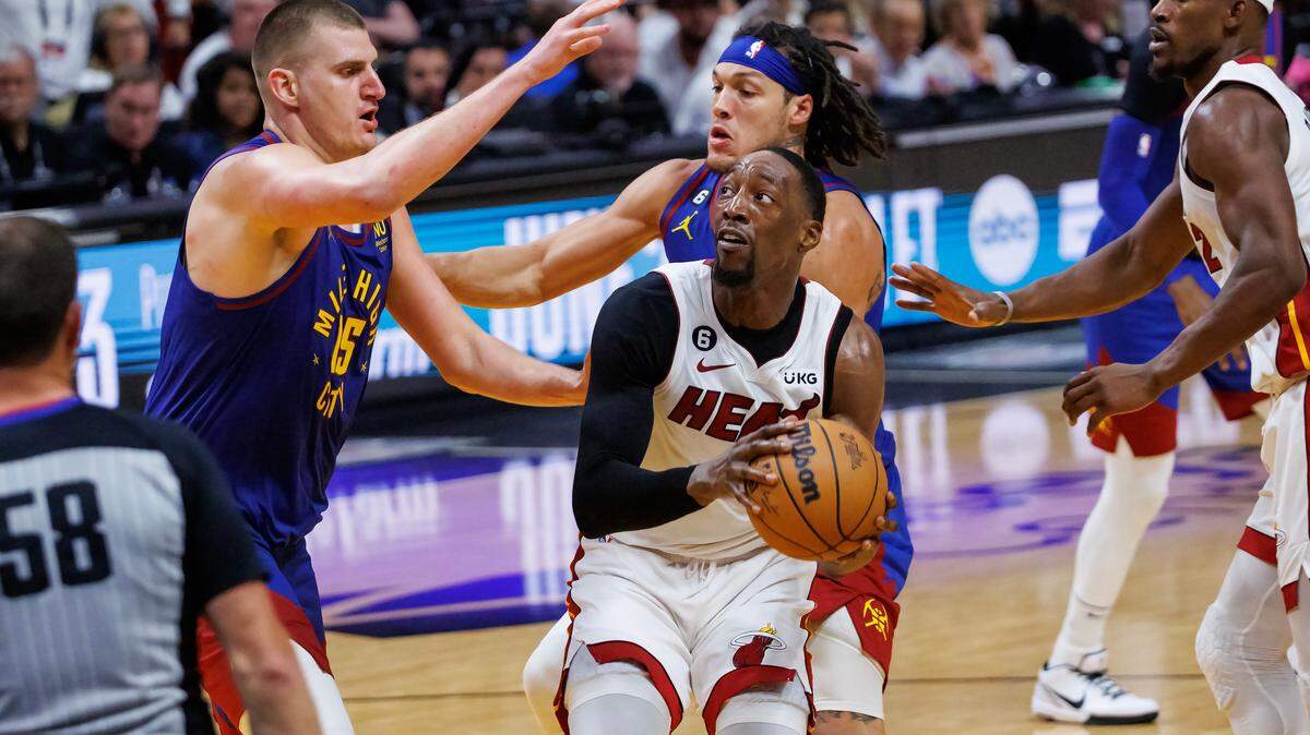 Miami Heat center Bam Adebayo (13) goes to the basket against Denver Nuggets center Nikola Jokic (15) during the second half of Game 3 of the NBA Finals at the Kaseya Center on Wednesday, June 7, 2023, in Miami, Florida.