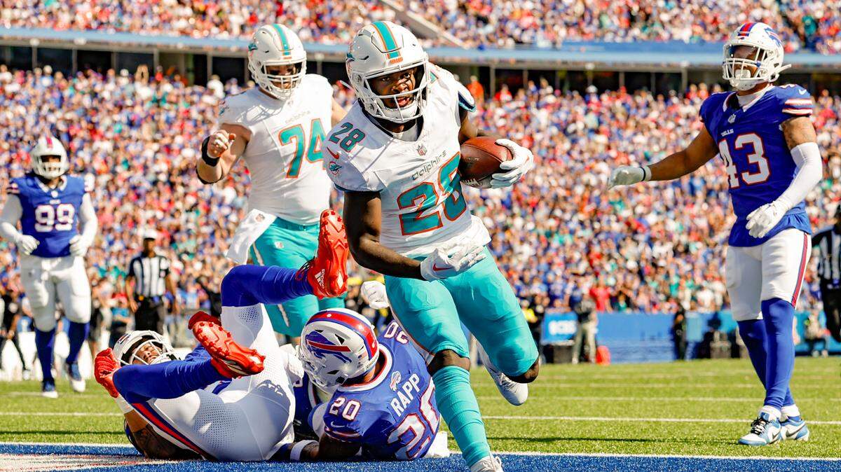 Miami Dolphins running back De’Von Achane (28) scores in the second quarter against the Buffalo Bills at Highmark Stadium in Orchard Park, NY., on Sunday, October 1, 2023.