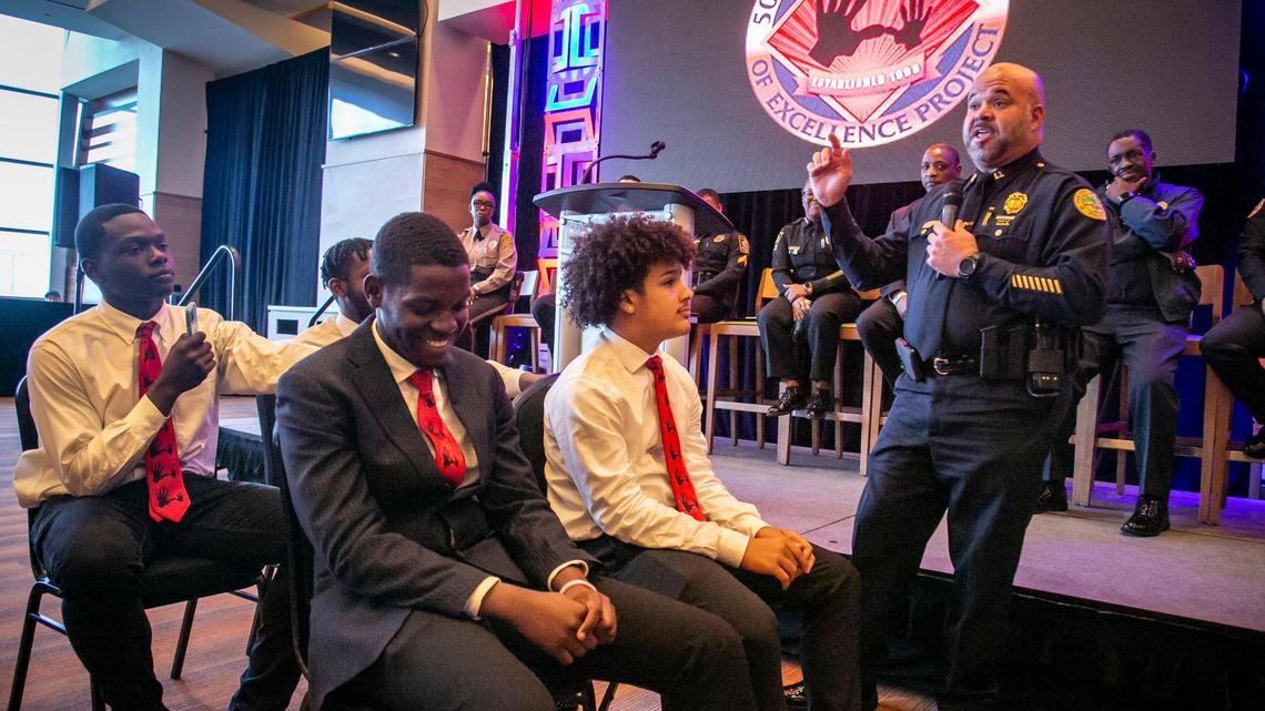 Cmdr. Robert Laurenceau of the Miami Police Department, right, talks to young men during a role-playing demonstration in one of the break-out sessions at a 5000 Role Models conference at Hard Rock Stadium.