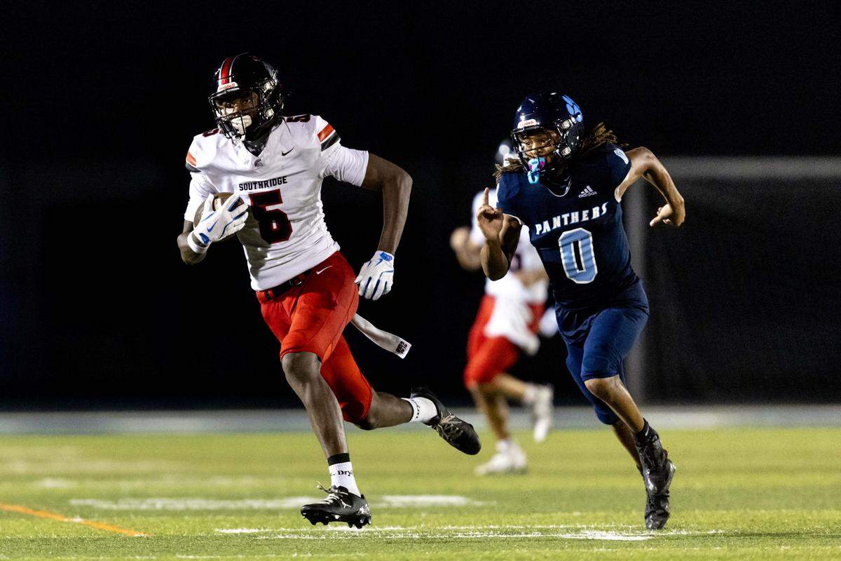 Spartans running back Varian Terry (5) runs past Panthers defensive back Kevin White (0) as he carries the ball during the first half of a high school football game between Palmetto and Miami Southridge at Tropical Park on Thursday, September 4, 2025, in Miami, Fla.