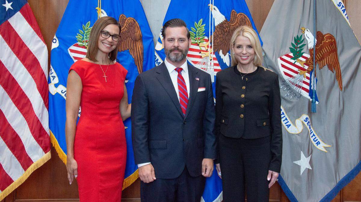 Jason A. Reding Quinones, center, is flanked by his wife, Jennifer Donates, left, and U.S. Attorney General Pam Bondi, right, after being sworn in as U.S. Attorney for the Southern District of Florida, Wednesday, Aug. 13, 2025, in Washington.