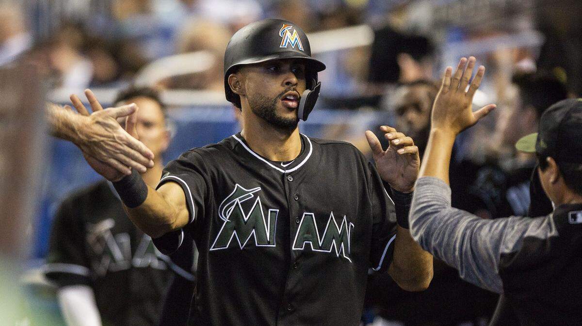 Miami Marlins infielder Yadiel Rivera (2) celebrates a run in the dugout during the seventh inning of a baseball game against the Washington Nationals at Marlins Park on Sunday, May 27, 2018, in Miami, FL.