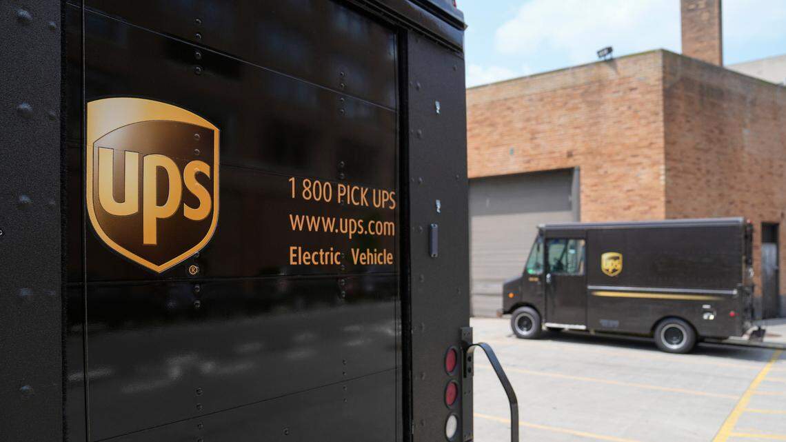 In this file photo, delivery vehicles remain idle outside a UPS depot, Thursday, June 29, 2023, in New York.