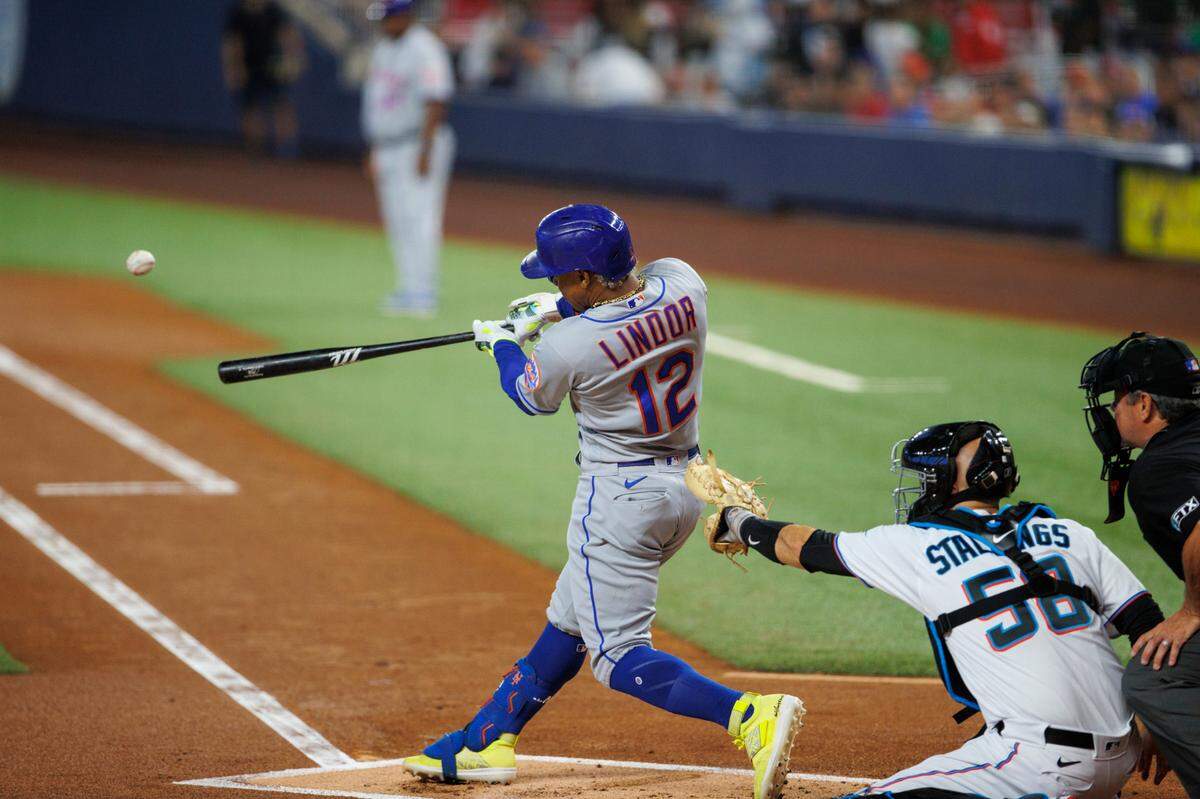 New York Mets shortstop Francisco Lindor (12) hits a double during the first inning of a baseball game against the Miami Marlins at LoanDepot Park on Sunday, July 31, 2022 in Miami, Florida.