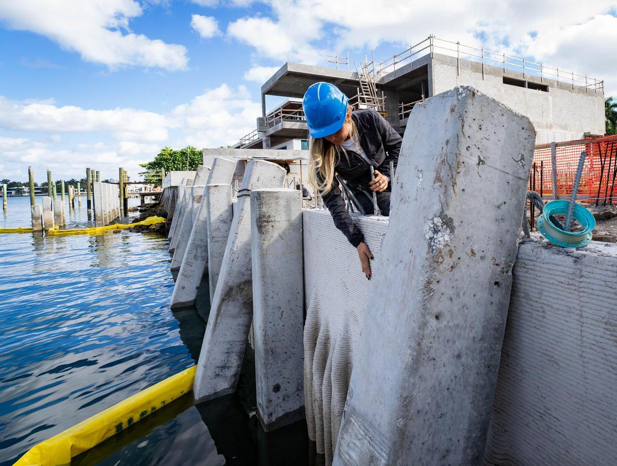 Founder and CEO of Kind Designs, Anya Freeman, inspects a 3D printed seawall in Miami Beach.