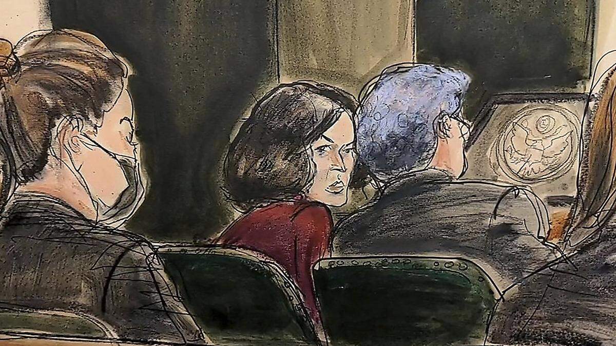 In a courtroom sketch, Ghislaine Maxwell center, confers with one of her defense attorneys during her sex-abuse trial in New York.