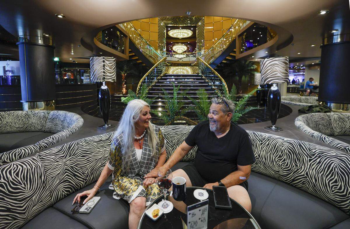 Guests Krystyna Harkey and Doug Harkey celebrate their 38 year wedding anniversary on MSC Poesia docked at PortMiami in Miami, Florida, on Wednesday, April 22, 2026. Built in 2008, it underwent refurbishment this year. This winter, it will be based at PortMiami heading on trips to the Caribbean. Bar