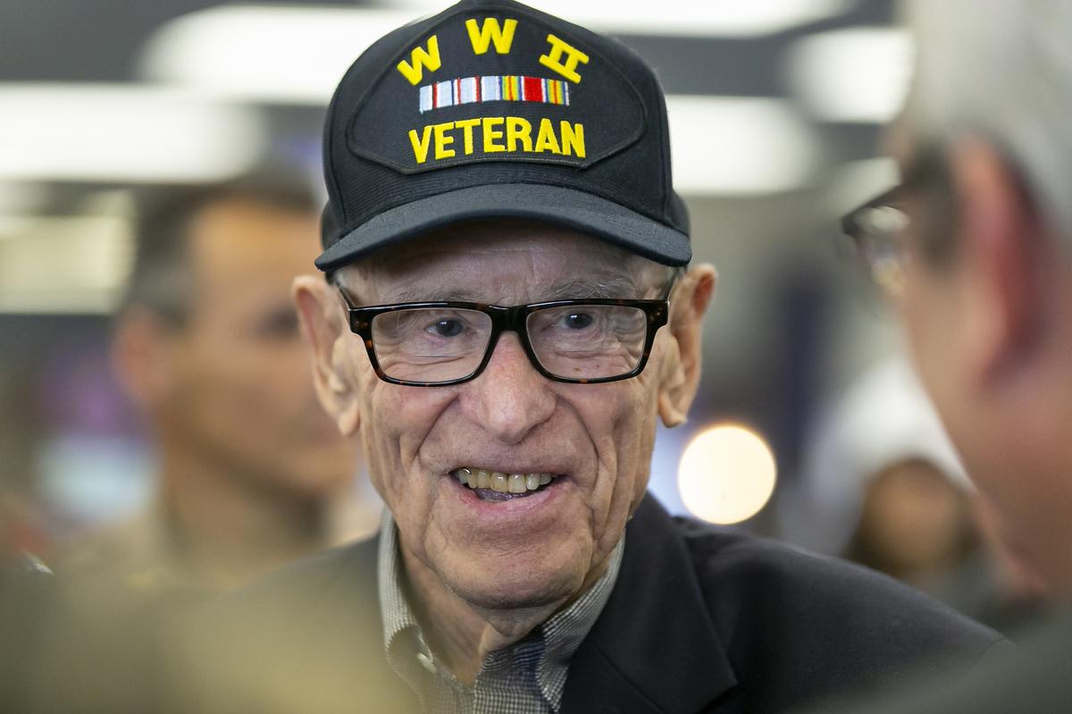 Sydney Levit, 94, an American World War II veteran, is greeted during a sendoff celebration at the Miami International Airport on Wednesday, May 22, 2019. Levit will be the only World War II veteran representing America as a guest of honor at the Memorial Day 75th Anniversary Ceremony at the Cambridge American Cemetery in England.