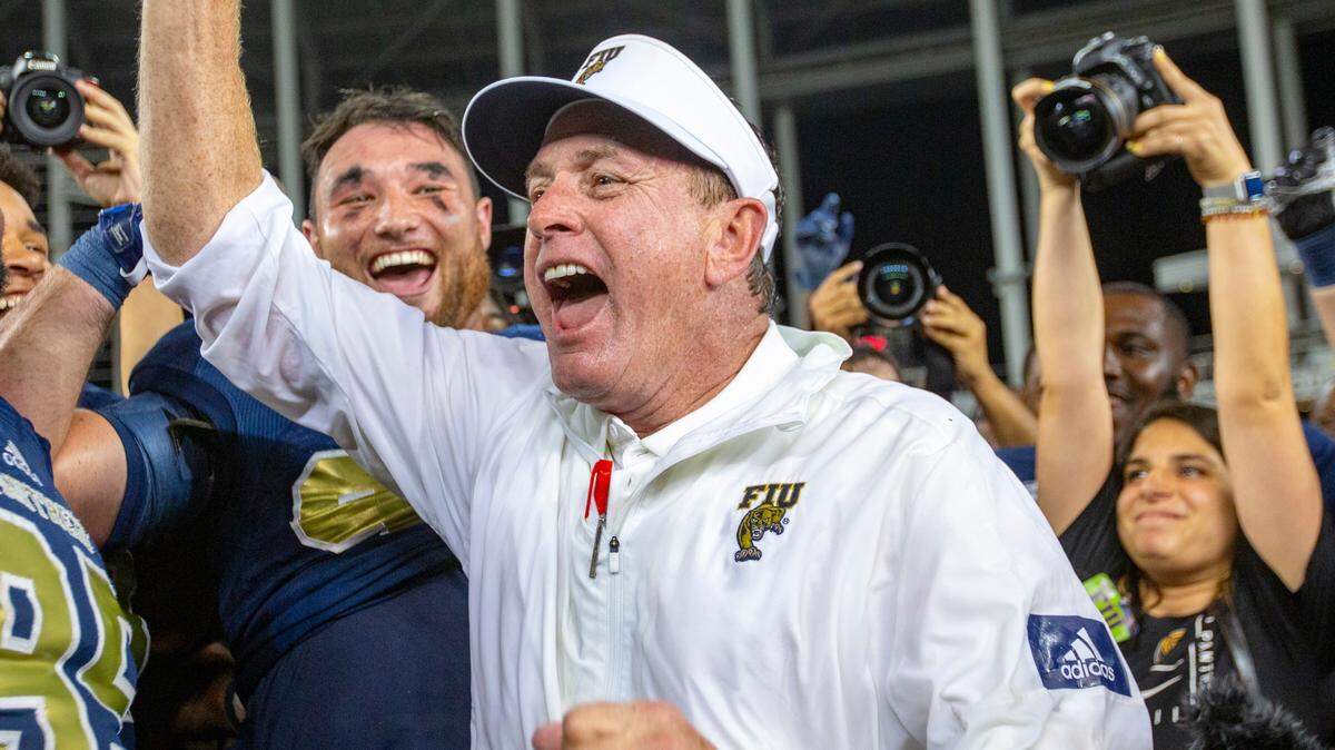 Florida International University head coach Butch Davis celebrates after FIU beat the Miami Hurricanes for first time ever in a football game at Marlins Park in Miami, Florida on Saturday, November 23, 2019.
