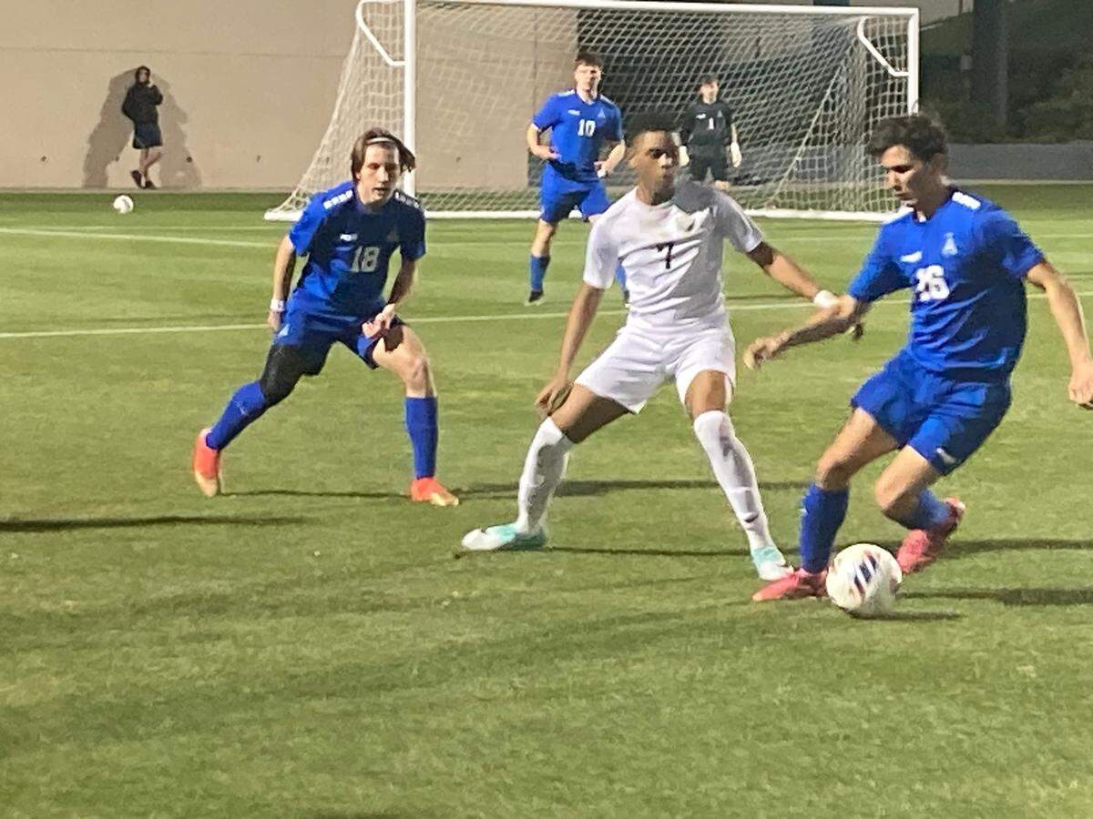 Pembroke Pines Charter’s Justin Treasure marks an Arnold player during Tuesday night’s Class 5A boys soccer state semifinal at Spec Martin Stadium in DeLand, Fla.