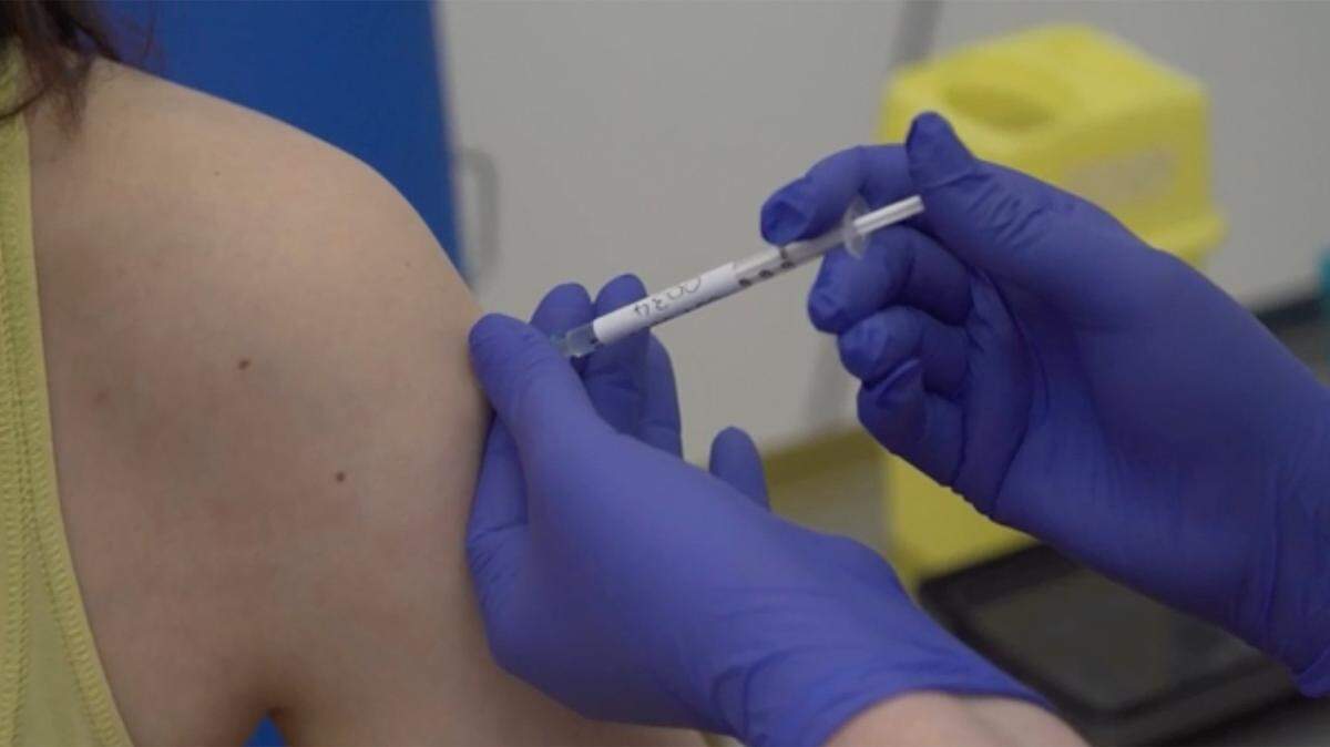 In this April 23 screen grab taken from video issued by Britain’s Oxford University, a person is being injected as part of the first human trials in the UK to test a potential coronavirus vaccine. Last week, hopes for a vaccine helped to push stock indices close to record highs.